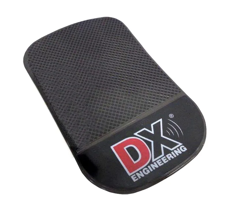 DX Engineering non-slip dashboard pad in black rubber with textured surface and DX Engineering logo